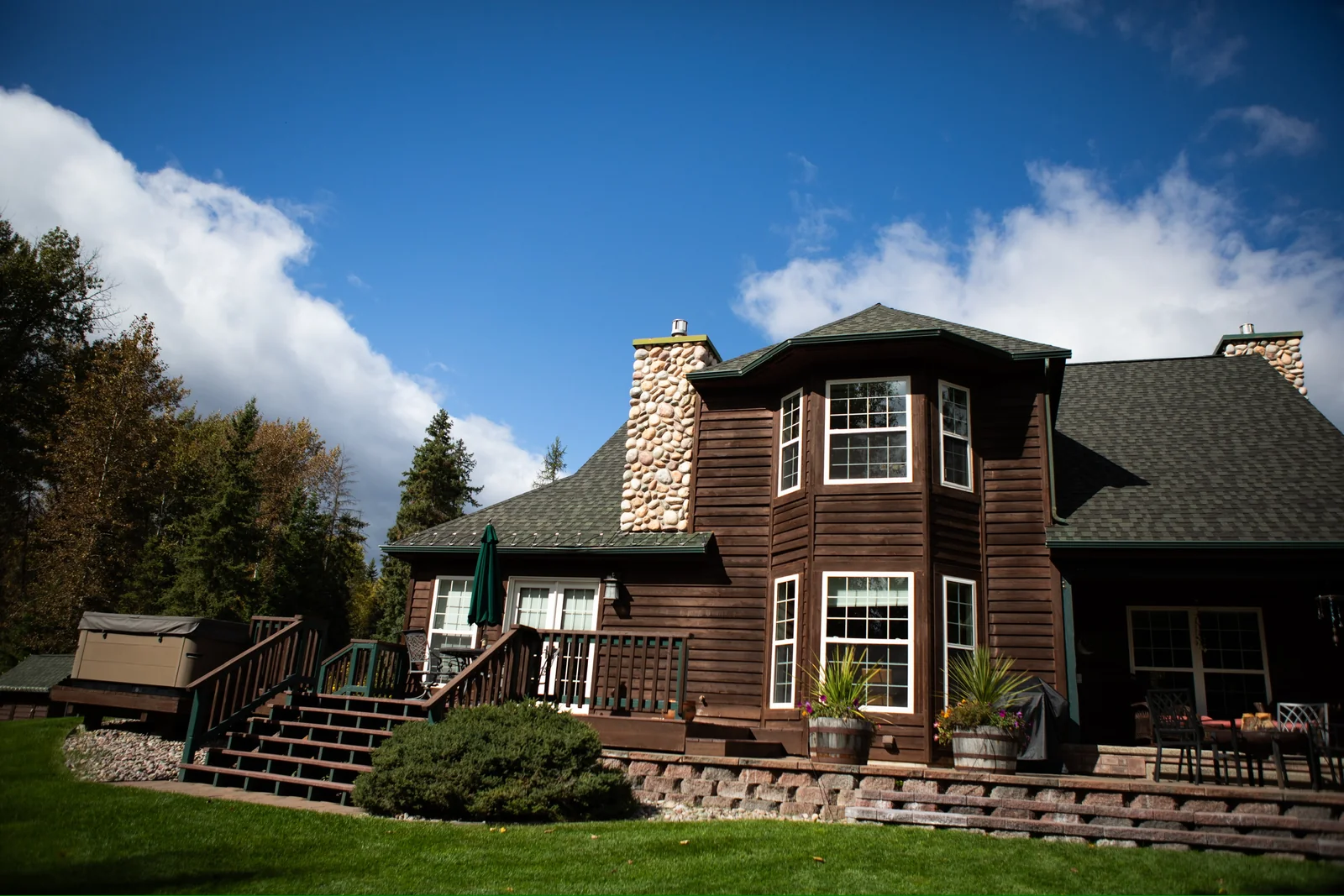 The main lodge at Blue Star with its stone chimney and lawn
