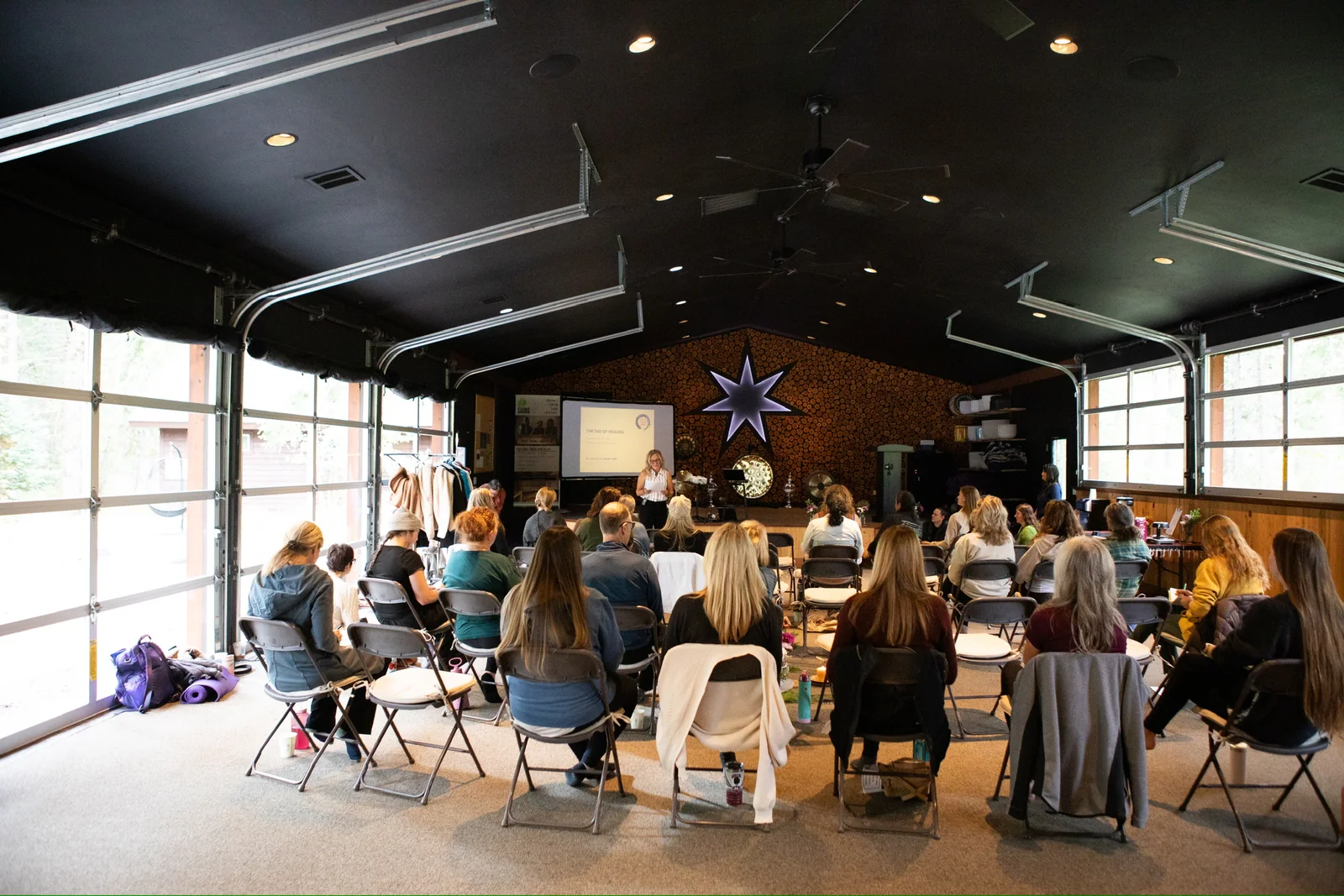 Guests gathered around tables during a workshop at Blue Star