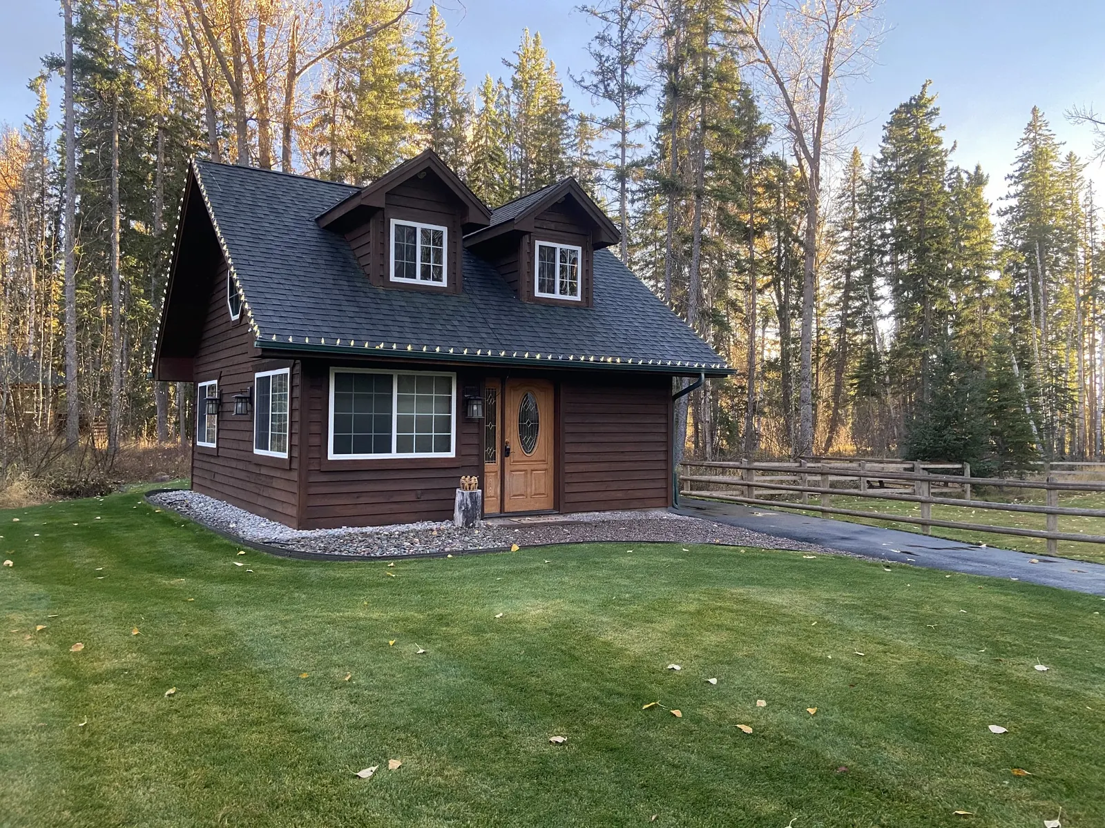 Cabin exterior with forest behind it