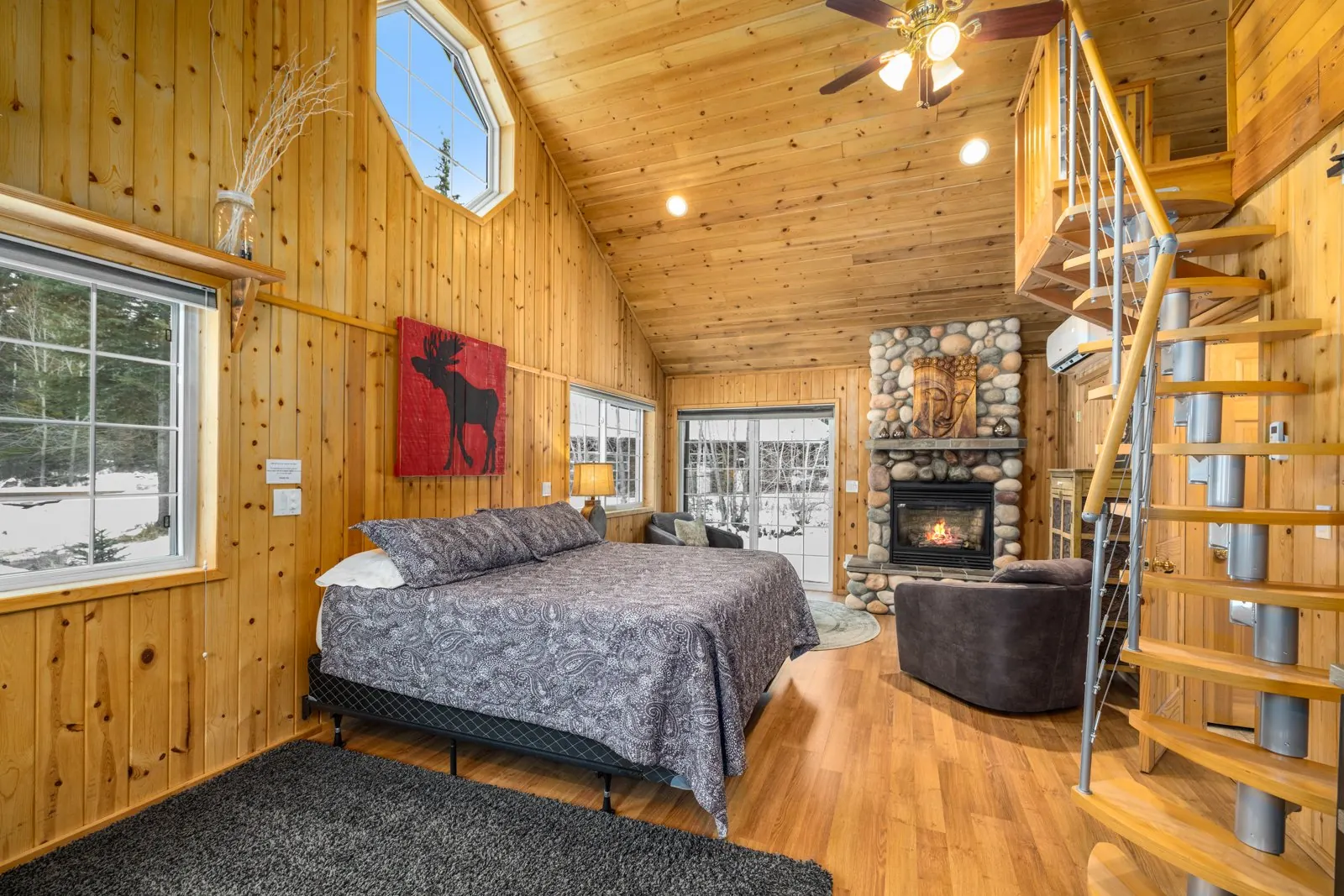 Cabin sleeping area, fireplace and spiral staircase