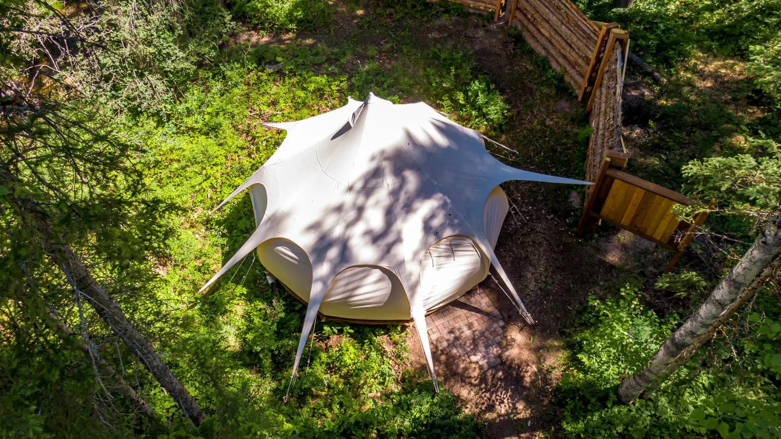 Aerial view of the Lotus Belle canvas tent in the woods