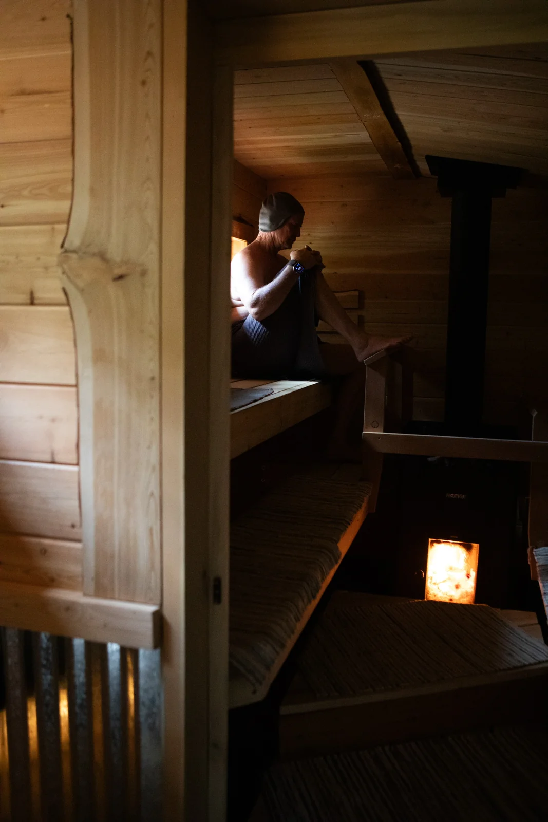 Warm light and a glowing wood stove inside Blue Star's Finnish sauna